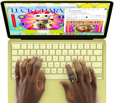 MacBook Neo amarelo-cítrico. As mãos de uma pessoa estão no teclado redigindo um e-mail com convite para uma exposição de arte. O site do evento está aberto ao lado