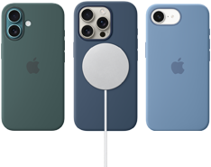 Vários acessórios MagSafe para iPhone. Capa de silicone com MagSafe para iPhone 16, verde-lago, capa de silicone com MagSafe para iPhone 16 Pro, denim, conectada a um carregador MagSafe branco, capa de silicone para iPhone 16e, azul-inverno